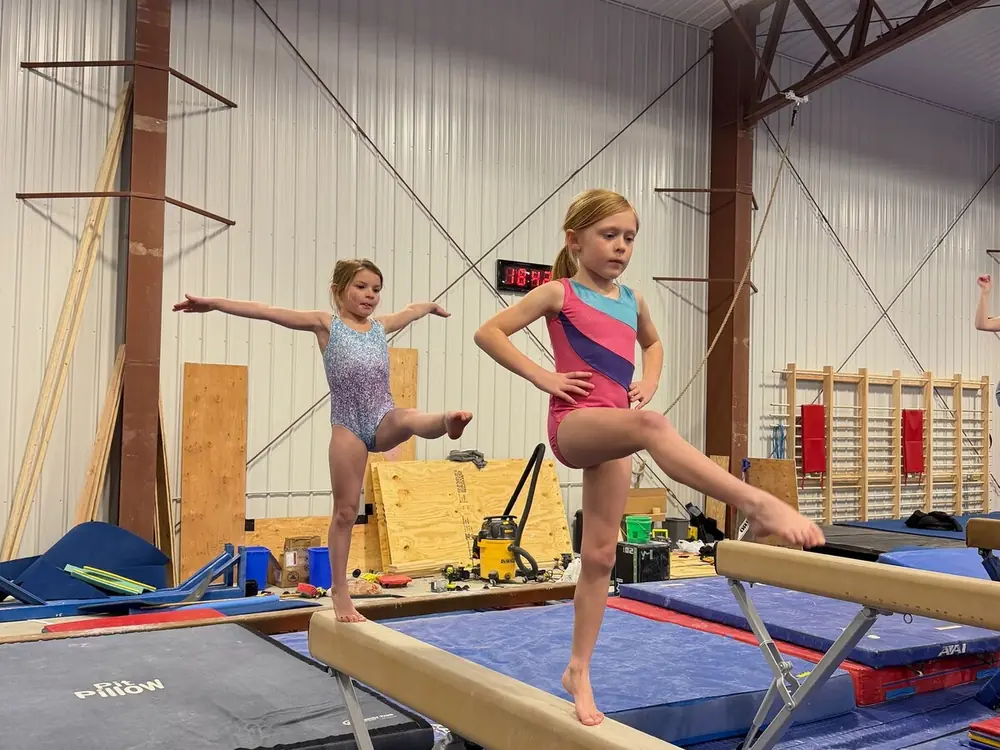 Children balancing on beams during a recreational gymnastics class